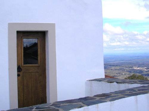 a view from a window of a building with a stone wall at Casa da Silveirinha in Marvão