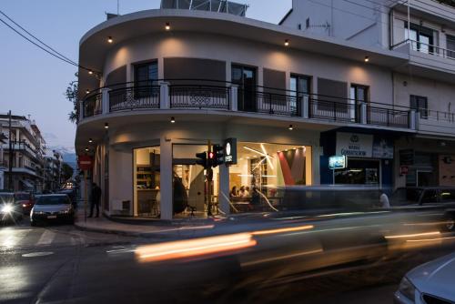 a building on the corner of a street with a traffic light at Cocoon City Hostel in Chania Town