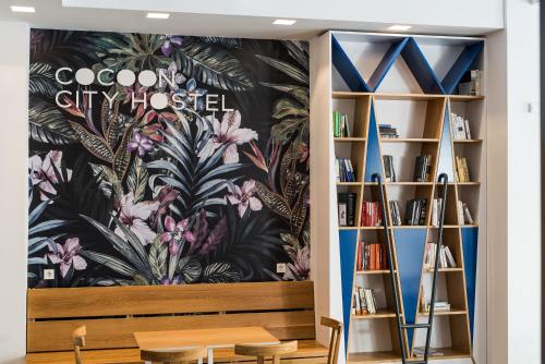 a room with a wall with a mural of flowers at Cocoon City Hostel in Chania Town
