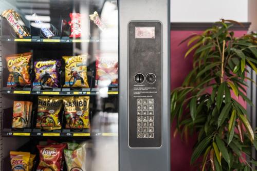 a vending machine with a display of chips at Cocoon City Hostel in Chania Town