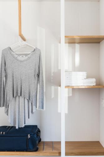 two images of a shirt hanging on a shelf at Cocoon City Hostel in Chania Town