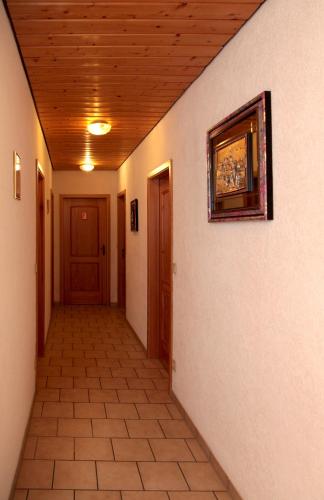a hallway of a house with a wooden ceiling at Pension La Cascina in Tuttlingen