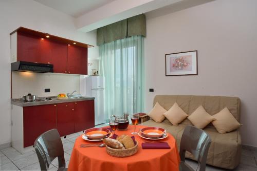 a living room with a table and a couch at Residence Margherita in Cattolica