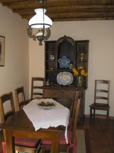 a dining room with a table and a chandelier at Casa da Silveirinha in Marvão