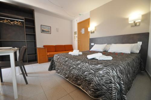 En eller flere senge i et værelse på Aparthotel Safari
