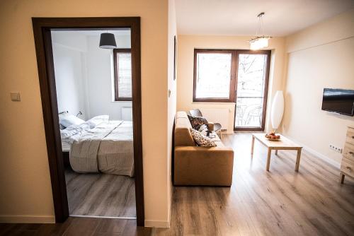 Ένα ή περισσότερα κρεβάτια σε δωμάτιο στο Apartamenty Opal