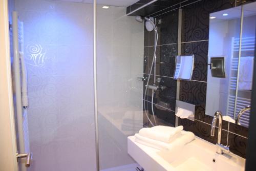 a bathroom with a shower, sink, and tub at Hôtel Le Quercy, Brive-la-Gaillarde Centre in Brive-la-Gaillarde