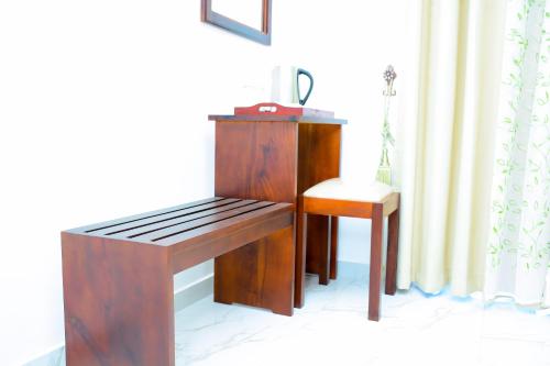 a wooden desk and a chair next to a window at Mama Beach Villa in Negombo