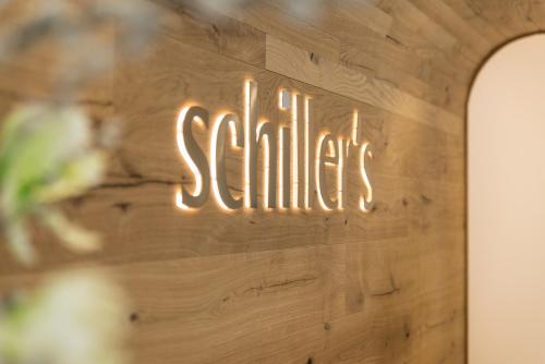 a sign that says smile on a wooden wall at Hotel Schiller in Olching