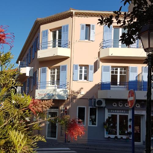 a building on the side of a street at Villa TerraMera Hôtel in Le Lavandou