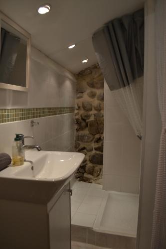 a bathroom with a sink and a shower at Maison Sous Le Pont in Meyras