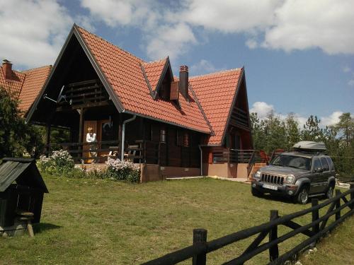 a car parked in front of a house at Chalet Four Seasons in Zlatibor