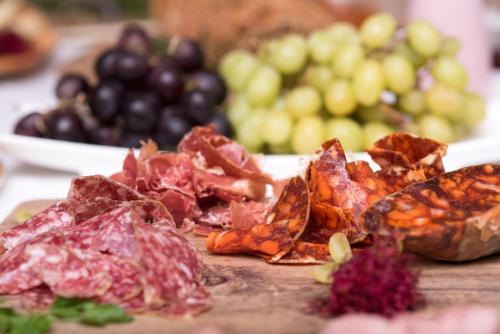 a plate of food with meat and fruit on a table at Casa Font i Roig in Maria de la Salut