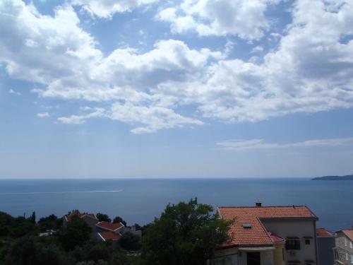 a view of the ocean from a house at Apartments Đurašević in Sveti Stefan