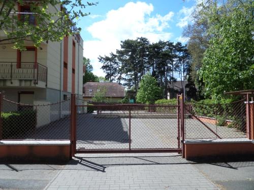a fence in front of a building at Sunny Apartman in Siófok