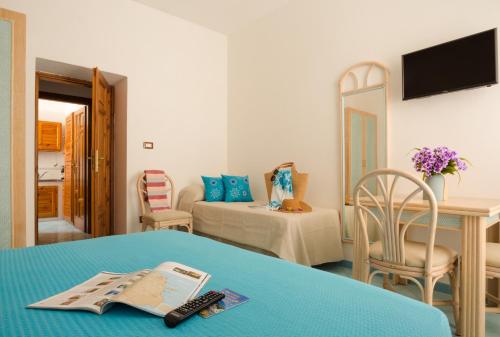 a hotel room with a bed and a table at Appartamenti Baia di Citara in Ischia