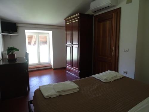 a bedroom with a bed with two towels on it at Casa Del Noce in Rovereto
