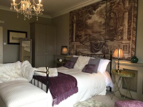 a bedroom with a bed and a painting on the wall at Hazel Manor in Harrogate