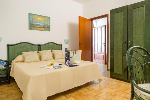 a bedroom with a bed with a table and chairs at Appartamenti Baia di Citara in Ischia
