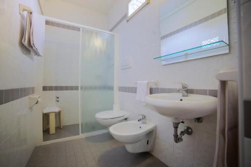 a bathroom with a sink and a toilet and a shower at Hotel Ideal Bianchini in Riccione