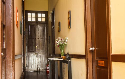 a hallway with a door and a vase of flowers at Villa La Punta in Lima