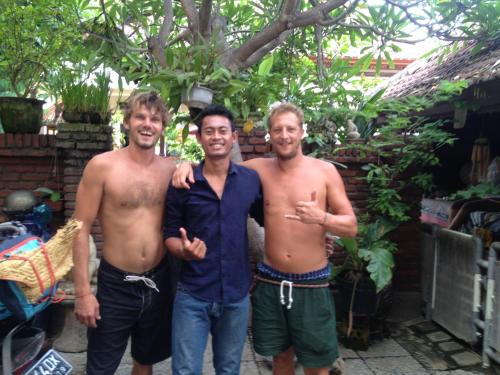 three shirtless men standing next to each other at Sari Buana Bed & Breakfast in Kuta