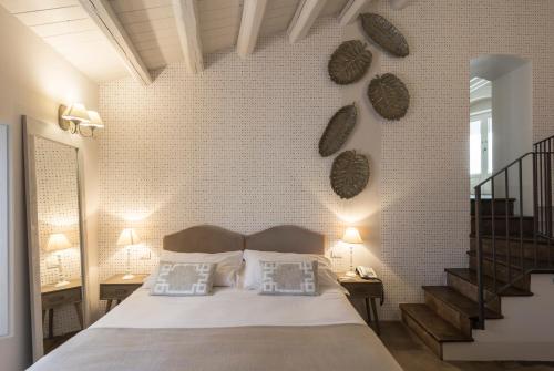 a bedroom with a bed and a brick wall at Locanda Don Serafino Historical Boutique Hotel in Ragusa