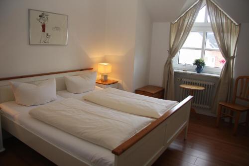 מיטה או מיטות בחדר ב-Sylter Apartments Wilhelmstrasse