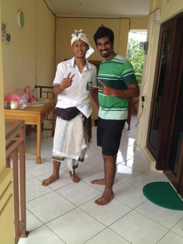 two men standing next to each other in a kitchen at Sari Buana Bed & Breakfast in Kuta