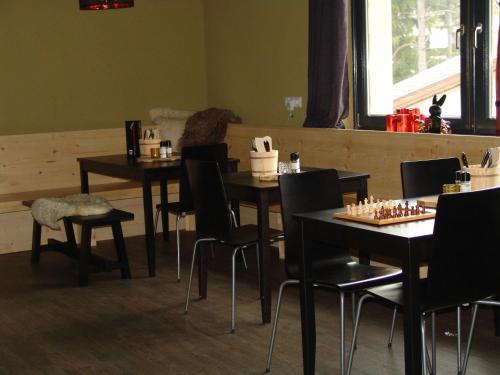 a dining room with tables and chairs with chessboards on them at Brabander Alm in Biberwier