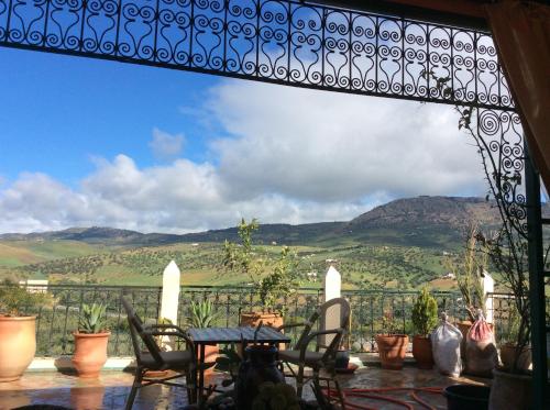 a view from the balcony of a house with a table and chairs at Riad Scalia Traditional Guesthouse Fes Morocco in Fès