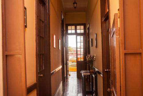 an empty hallway with an open door to a room at Villa La Punta in Lima