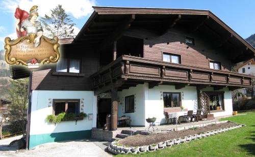 a large wooden house with a sign in front of it at Haus Jochblick Familie Loinger in Itter
