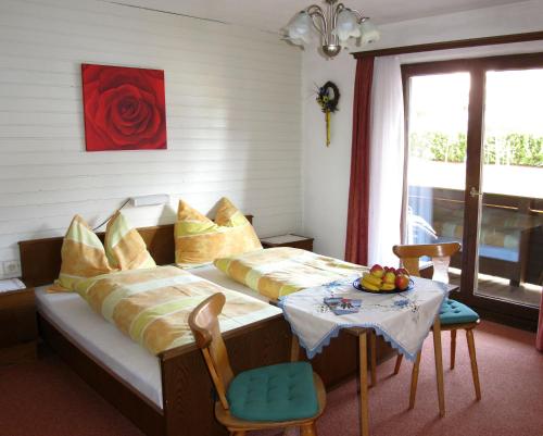 a bedroom with a bed and a table with fruit on it at Haus Jochblick Familie Loinger in Itter
