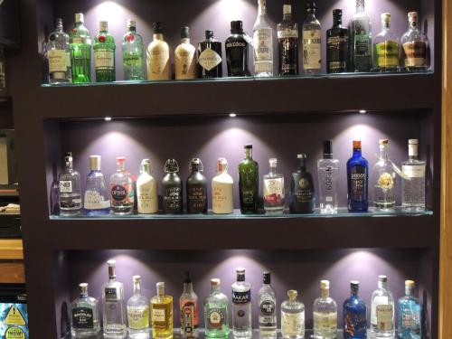 a shelf filled with lots of bottles of alcohol at The Orkney Hotel in Kirkwall