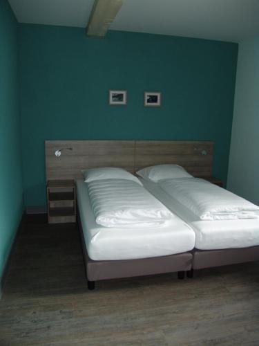 two beds in a bedroom with a green wall at Brabander Alm in Biberwier