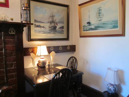 a dining room with a table with a lamp on it at White Owl Holiday Apartments in Robin Hood's Bay