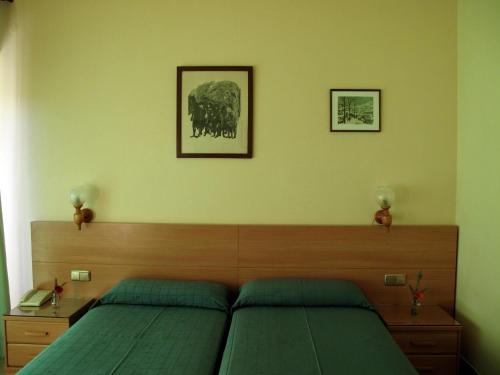 Ένα ή περισσότερα κρεβάτια σε δωμάτιο στο Hotel Martinez