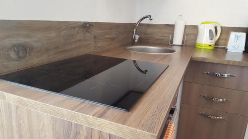 a kitchen counter top with a sink and a sink at Luz House in Tavernola Bergamasca