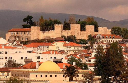 a city with a castle on a hill with buildings at Quinta das Arribas in Abrantes