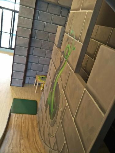 a mural of a plant on a brick wall at Jack Castle in Tainan