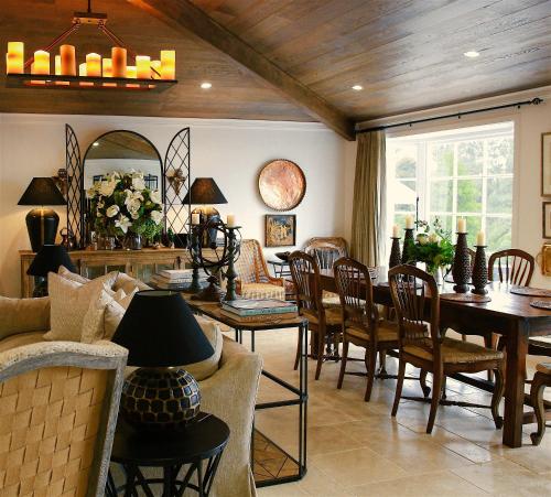 a living room with a table and chairs at Ngamihi Lodge in Rotorua