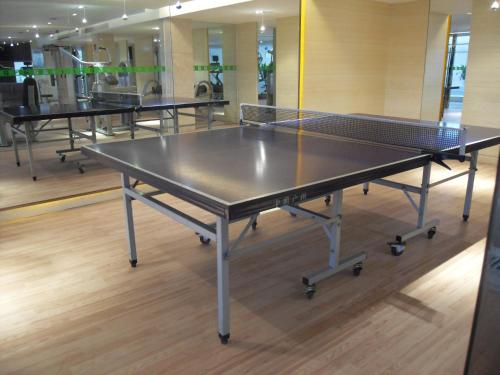 a ping pong table in a room with three tables at Haiwahai Hotel - Thousand Island Lake in Thousand Island Lake