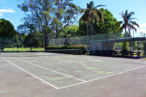 a tennis court with a tennis racket on it at Hive Hotel, Moruya in Moruya
