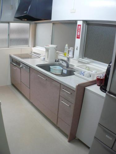 a kitchen with a sink and a counter top at Hotel Meigetsu in Tokyo