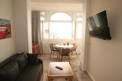 a living room with a couch and a table at Apartment Feodora in Sassnitz