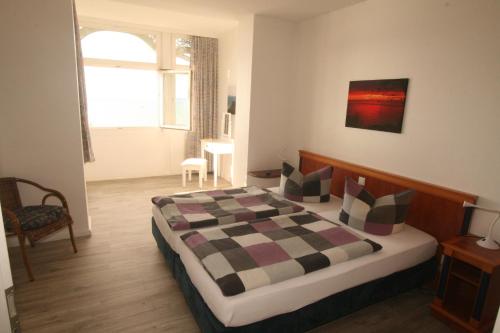 a bedroom with a bed with a checkered blanket at Apartment Feodora in Sassnitz