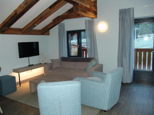 a living room with a couch and a tv at Brabander Alm in Biberwier