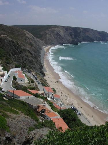 a view of a beach with cars parked on it at Quinta de Moledos in Aljezur