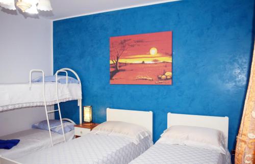 CorsanoにあるB&b Tratturiの青い壁の客室で、二段ベッド2台が備わります。